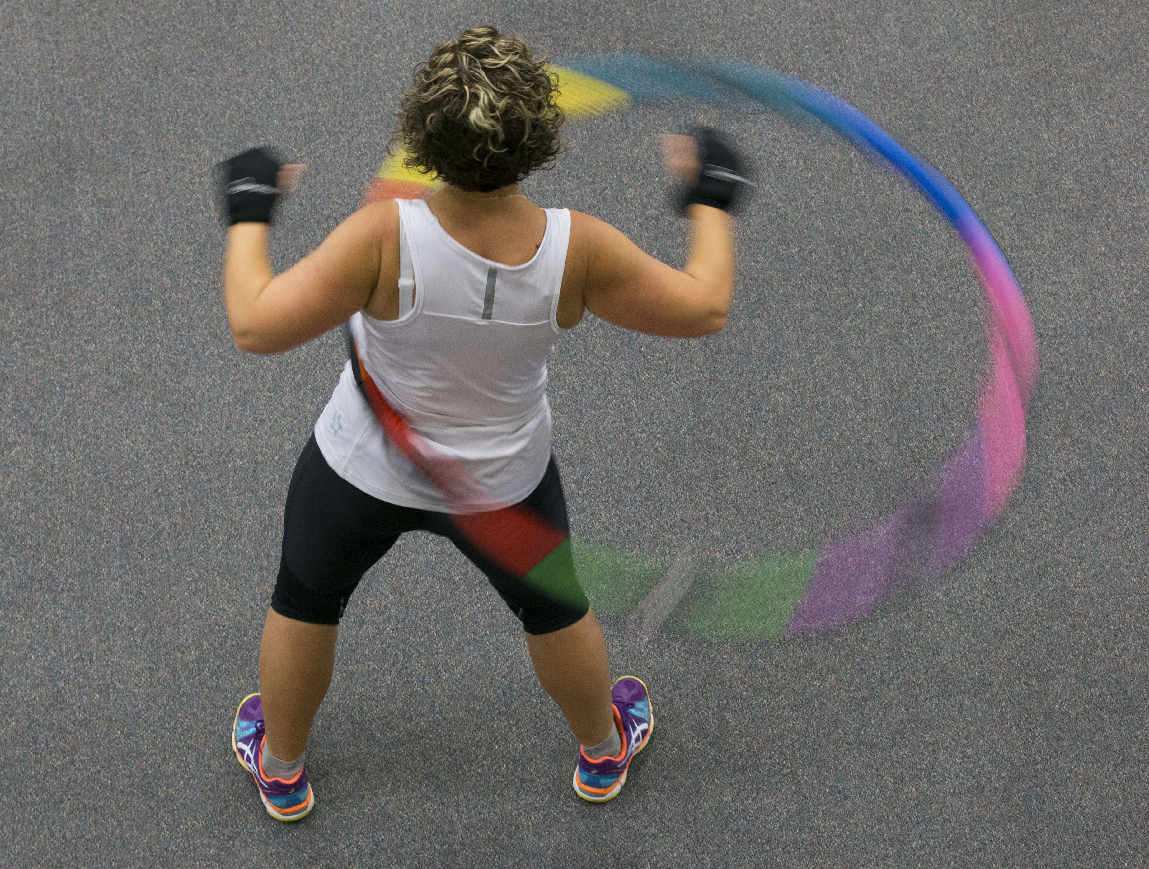 What is weighted hula hooping and why is it good for runners?